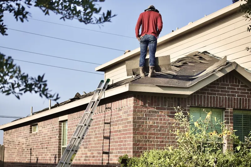 Professional roofer working on a residential roof in Stagecoach Forest